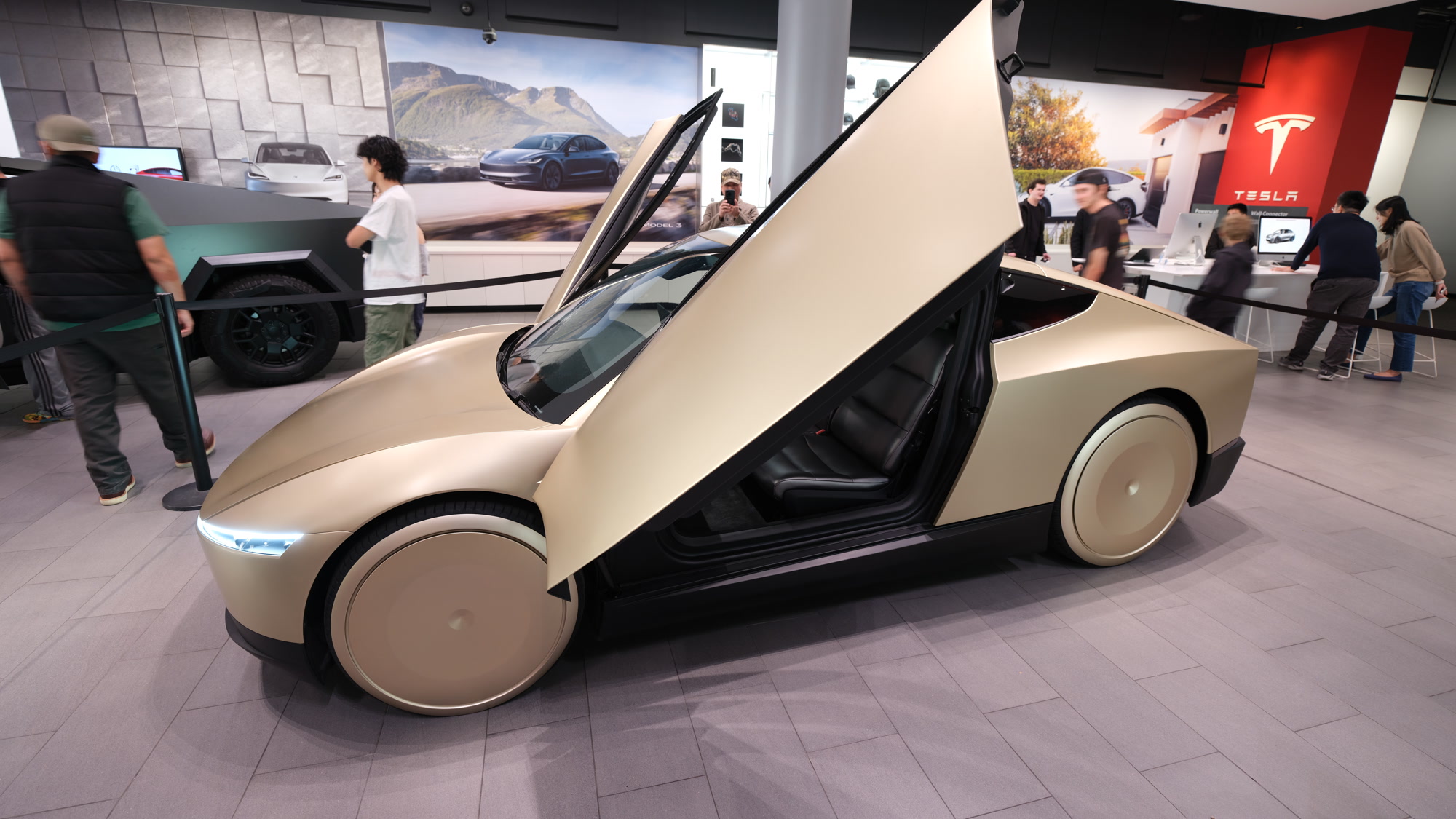 Gold Tesla Cybercab with butterfly doors open