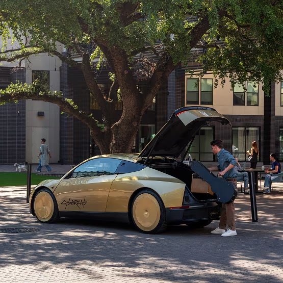 Gold Cybercab in an Austin plaza with trunk open
