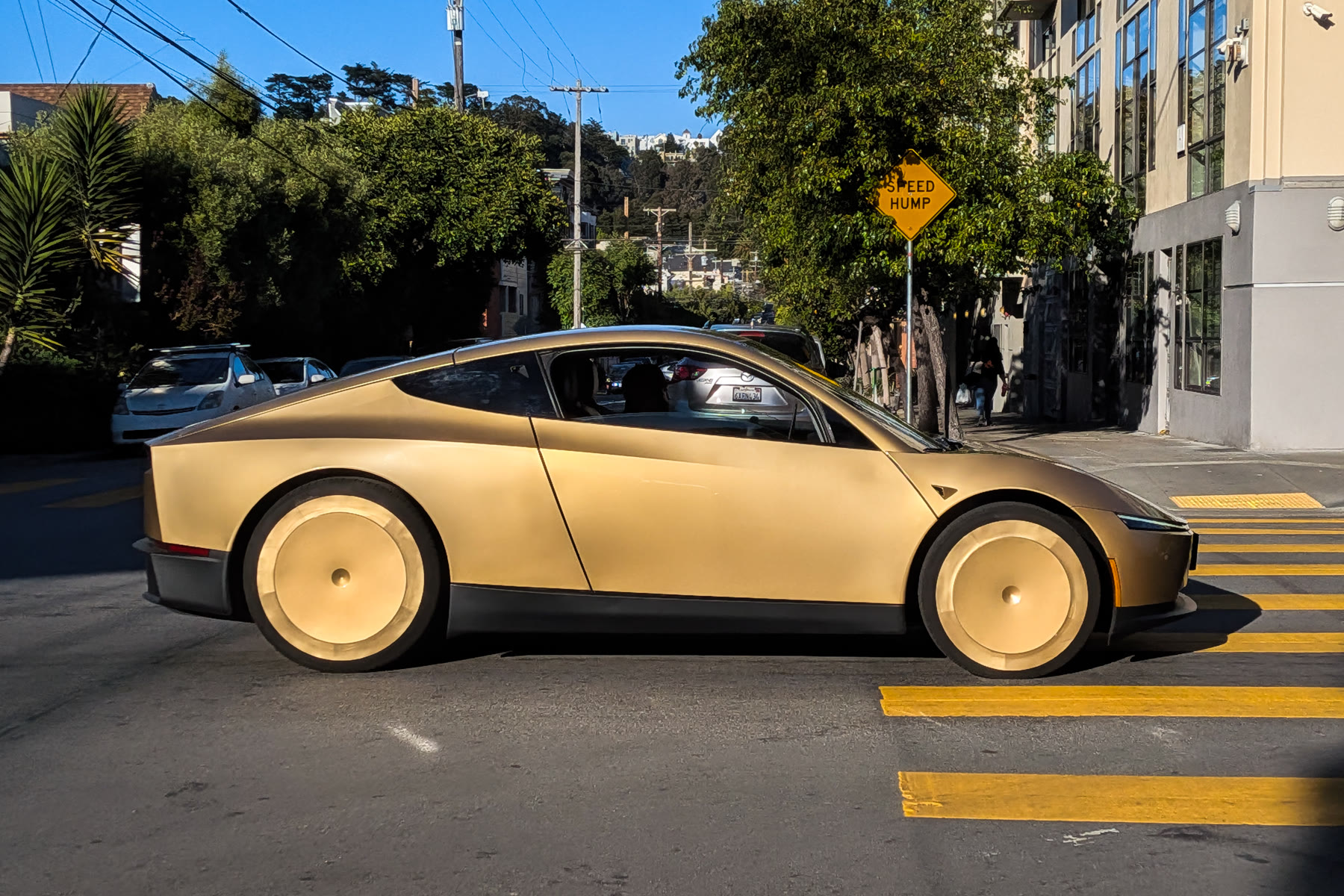 Gold Cybercab on a city street